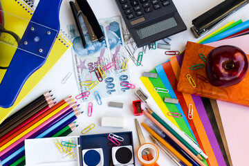 Colorful school supplies on white background with Turkish Money.School shopping concept.