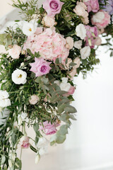 Close up flowers on the wedding arch with the place for your text. Wedding decoration. Floral background