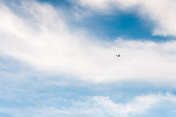 High blue sky with feathery clouds. The sky is a symbol of vastness, freedom, and air.