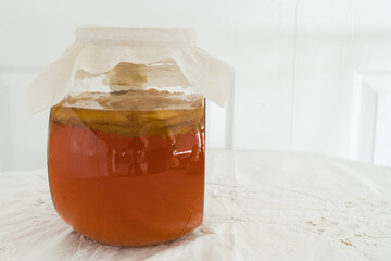 Bottle of sweet black tea with kombucha scoby brewing to make probiotic healthy drink