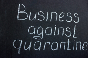 
The lettering on the chalk board "Business against quarantine". The slogan of modern reality