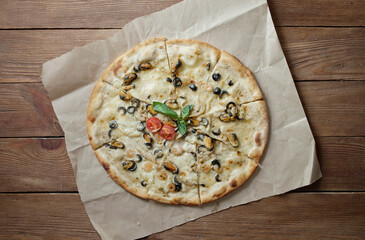 Delicious pizza with seafood and mozzarella, mussels, shrimp, squid. Food photo.