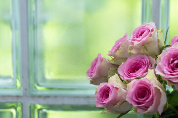Bouquet of roses against the background of the window