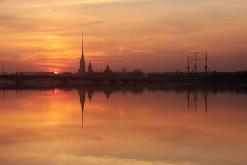 Fototapeta na wymiar Sunset over Neva river with the silhouette of the Peter and Paul Fortress, Saint Petersburg, Russia