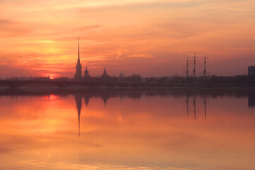 Fototapeta na wymiar Sunset over Neva river with the silhouette of the Peter and Paul Fortress, Saint Petersburg, Russia