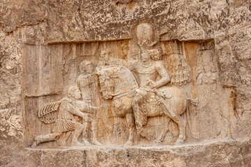 Rock relief of Shapur I,  Sasanian king shows defeated two Roman emperors Philippus Arabs and Valerian in Naghshe Rustam Near Shiraz, Iran