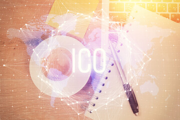 Blockchain theme hologram drawings over computer on the desktop background. Top view. Multi...
