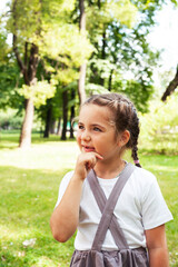 Fototapeta premium little cute caucasian girl playing cheerful in green park at summer, lifestyle people concept