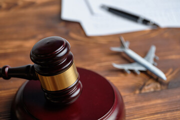 Concept of infringement of the rules of flying on an airplane next to the judge hammer
