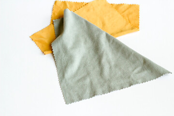 Anti-scratch, soft lens or eyeglass cleaning cloths on white surface with copy space