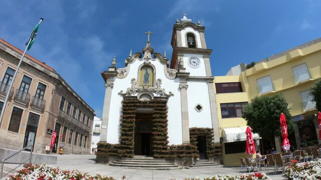 Vila Praia de Ancora / Caminha / Portugal - July 8, 2020: Flowers decorating the outside of the grand old church Capela de Nossa Senhora da Bonan&ccedil;a, the chapel dedicated to Our Lady of Bonanca.