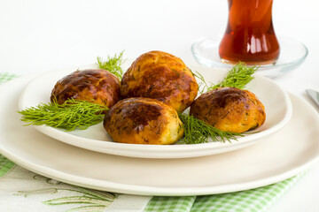 Homemade salty pastry on white background with traditional Turkish Tea.