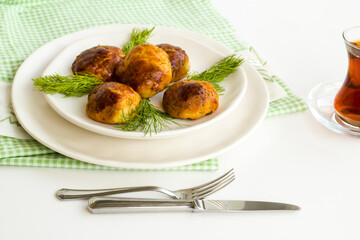 Homemade salty pastry on white background with traditional Turkish Tea.