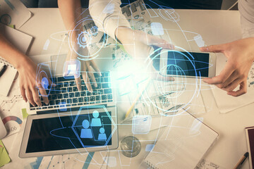 Double exposure of man and woman working together and social network theme hologram drawing. Computer background. connecting concept. Top View.