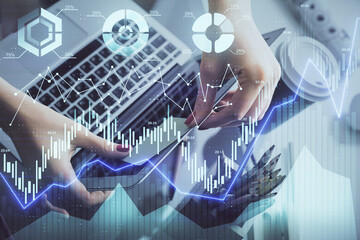 Double exposure of businesswoman hands typing on computer and financial graph hologram drawing. Stock market analysis concept.