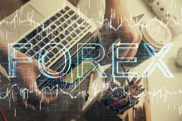 Double exposure of businesswoman hands typing on computer and financial graph hologram drawing. Stock market analysis concept.
