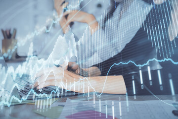 Fototapeta premium Multi exposure of woman hands typing on computer and financial graph hologram drawing. Stock market analysis concept.