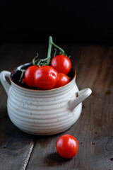 Cherry Tomatoes over wooden desk, Fresh colorful ripe Fall heirloom tomatoes over wooden background, top view, horizontal composition