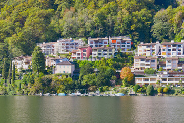 Fototapeta na wymiar Small Morcote town by the shore of Lake Lugano in Switzerland, houses between the lake and the mountain