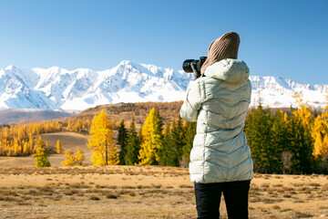 Woman On Mountain Hike in Autumn. Woman Tourist Taking Photo.