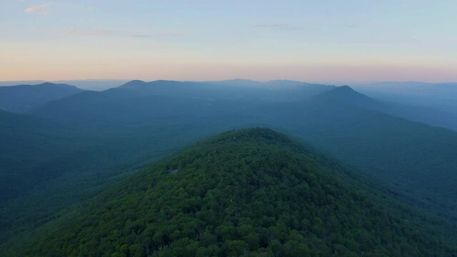 An aerial shot (dolly out) above Duncan Knob and Catback Mountain in the Massanutten Range in George Washington National Forest in Page County, VA. The Fort Valley is seen to the north.