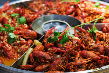 close up many steamed spicy Red Swamp Crayfish in big pot. blur background. popular food in China