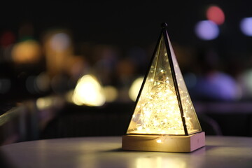 close up light on outdoor table at night. colorful bokeh background. outdoor cafe and restaurant...