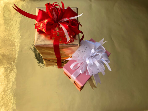 photo close-up Christmas boxes with presents on a gold background