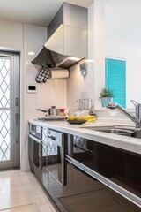 Vertical pictures of kitchen counters, sinks, and hoods in the home