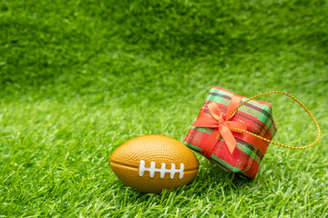 American Football Christmas Gift on green grass with gift