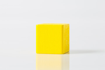 yellow wooden geometric shapes cube isolated on a white background