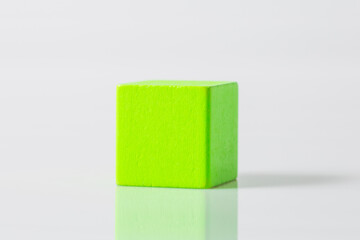 green wooden geometric shapes cube isolated on a white background