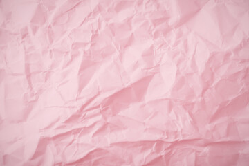 Top view of  pink crumpled paper background.