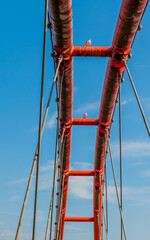 Three seagulls perched on bridge.