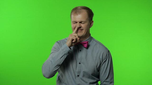 Funny stupid man picking nose. Silly brainless humorous expression, removing boogers, bad manners