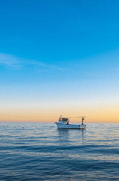 fishing boat and sunset on calm sea