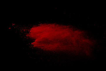 Red powder explosion on black background. 