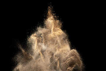 Gold sand explosion isolated on black background. Abstract sand cloud. © piyaphong