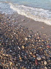 Colored stones and waves of the sea