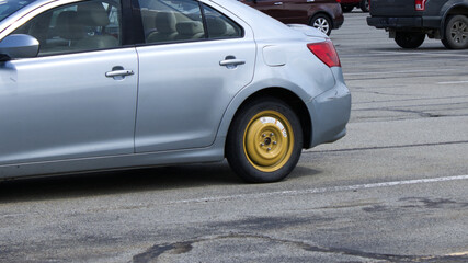 Car With Emergency Spare Tire in Use