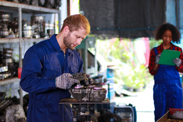 Fototapeta na wymiar Two mechanics at work. Two confident auto mechanic working at the repair shop.