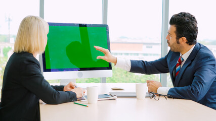 Business people in the conference room with green screen chroma key TV or computer on the office...