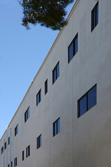 Fototapeta na wymiar Low angle view of the uniform facade of an uninspiring general business building