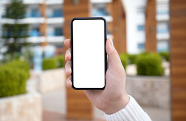 male hand hold phone with isolated screen in city background
