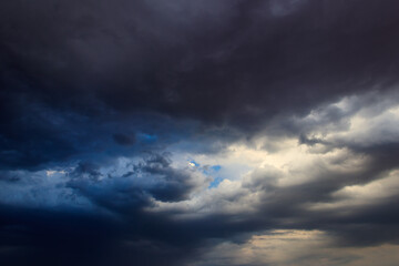 Naklejka na ściany i meble Dark storm clouds in sky before thunderstorm and rain. Dramatic sky background