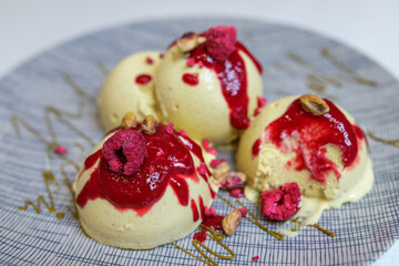 Pistachio ice cream balls with raspberry and berry sauce