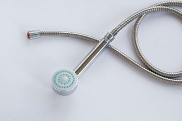 New,unused stainless steel of shower head and apparatus on white surface,top view