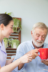 Nurse assist senior man having breakfast together