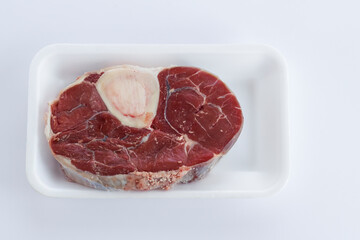 Uncooked,shank marrow bone of beef on the white packing,with stretch film wrapped