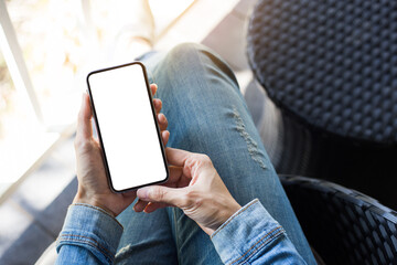 cell phone mockup image blank white screen.woman hand holding texting using mobile on desk at coffee shop.background empty space for advertise.work people contact marketing business,technology